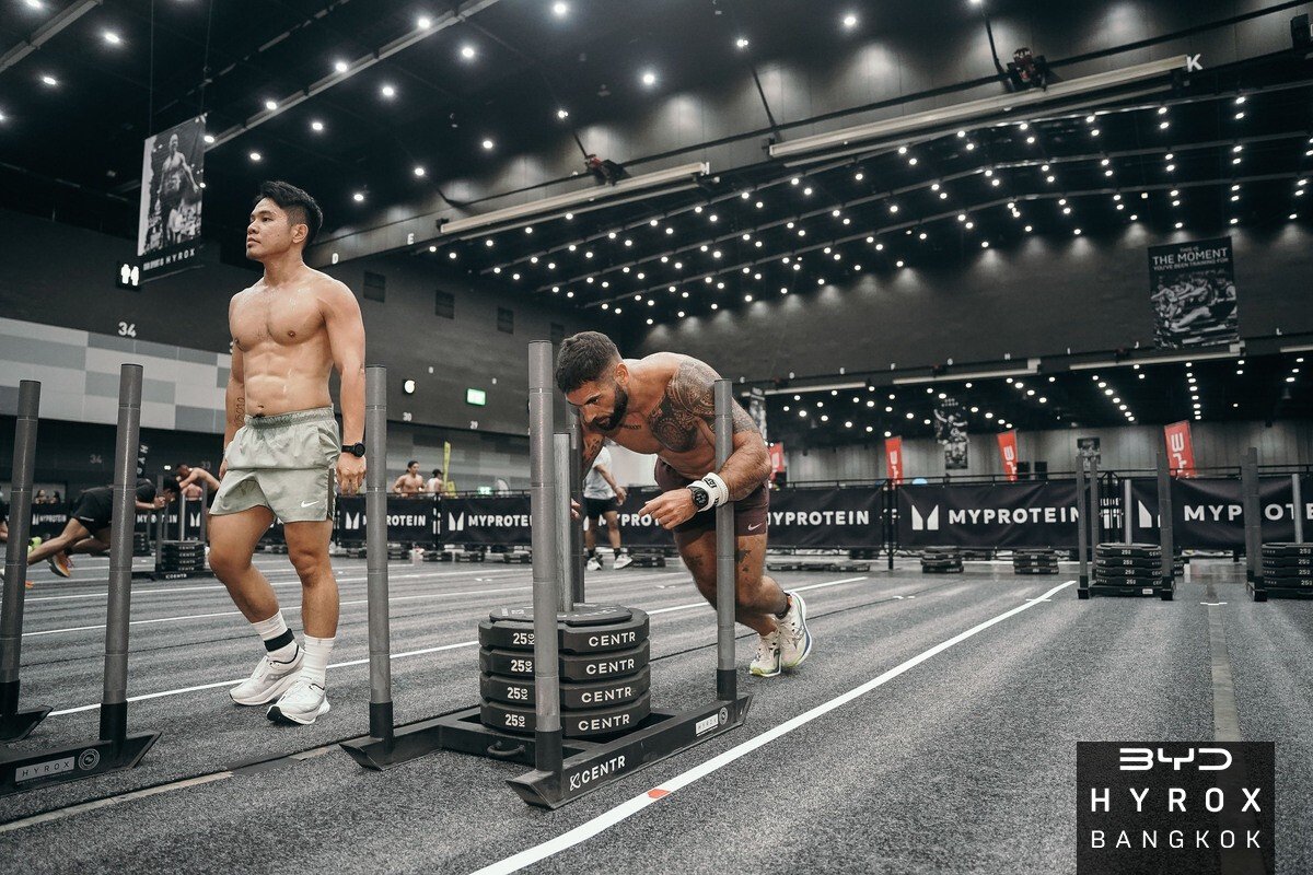 Steven pushing a weighted sled during a HYROX competition