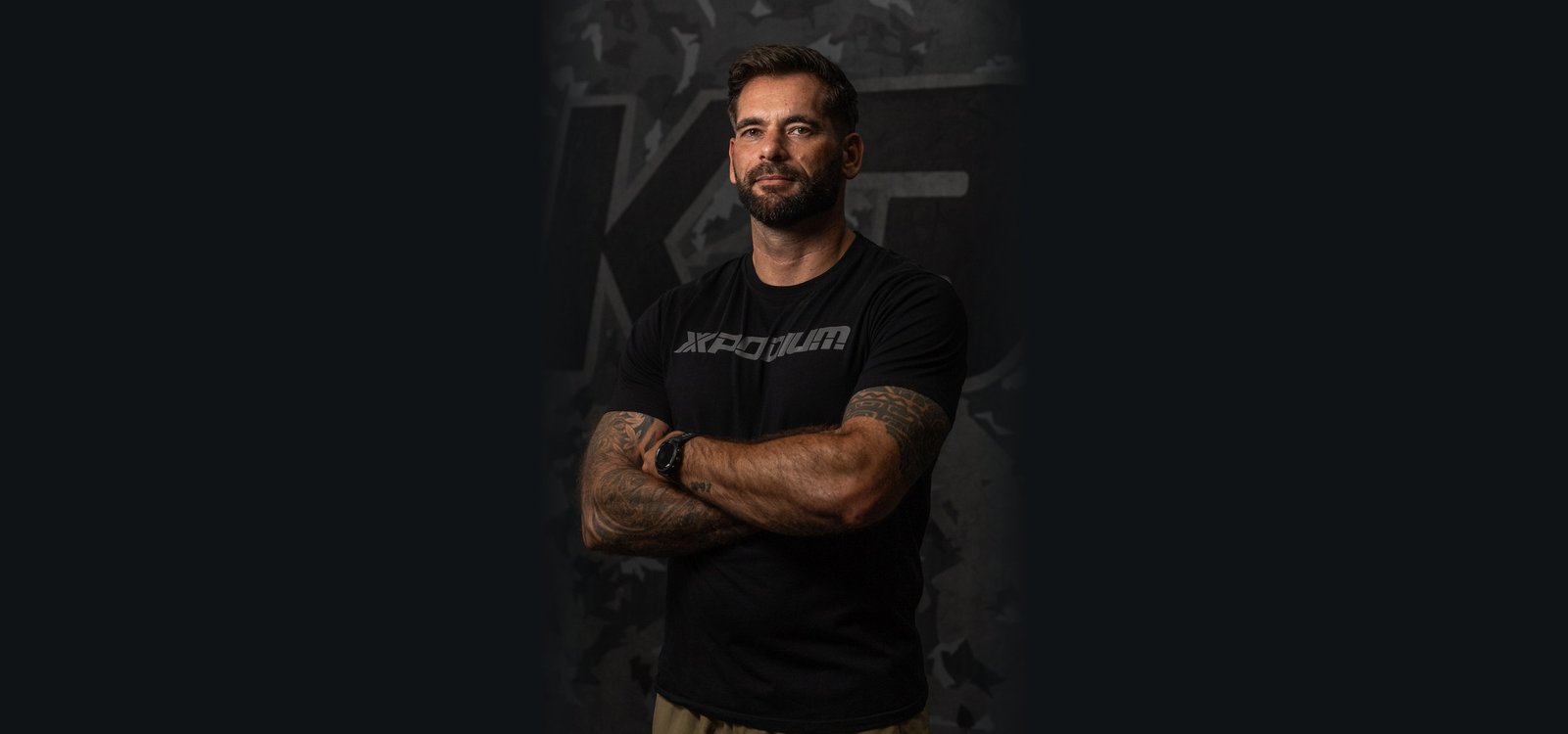 Portrait of Coach Steven with his arms crossed
