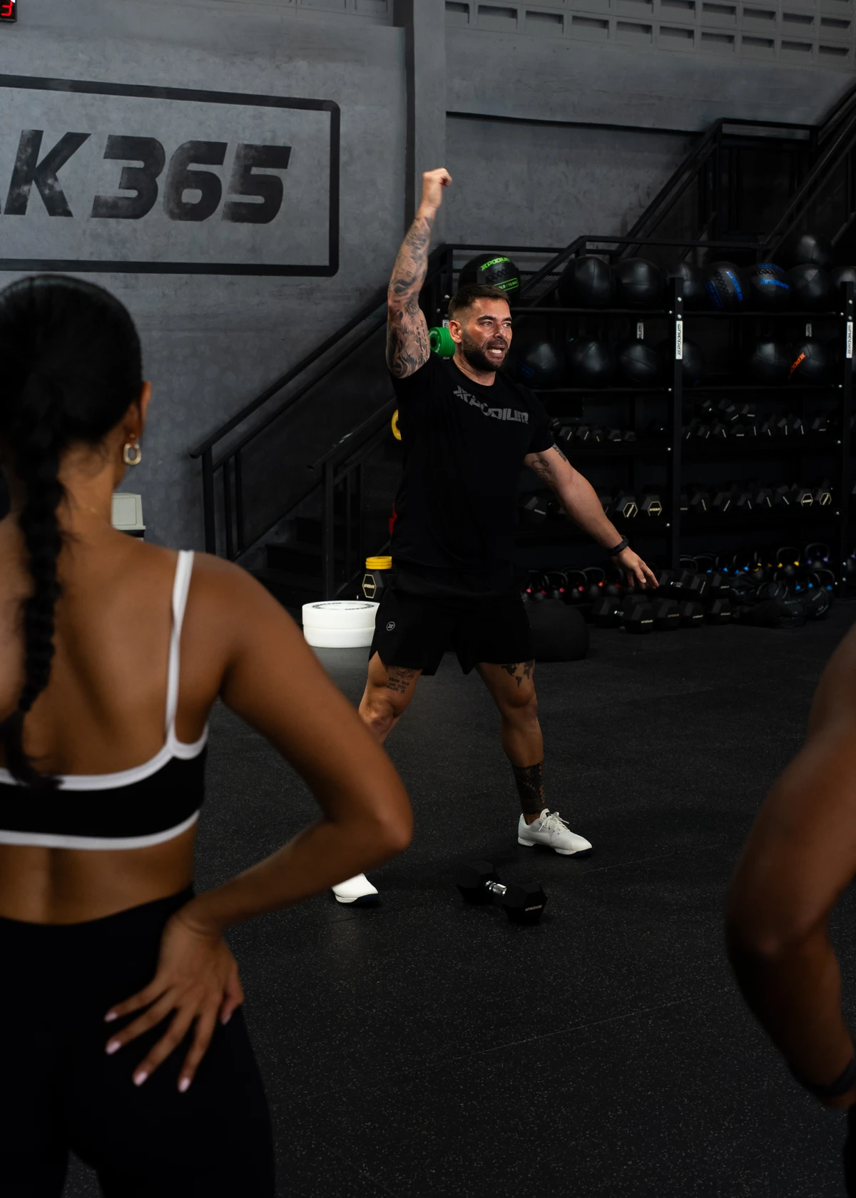 Steven giving focused movement instruction to athletes on the gym floor
