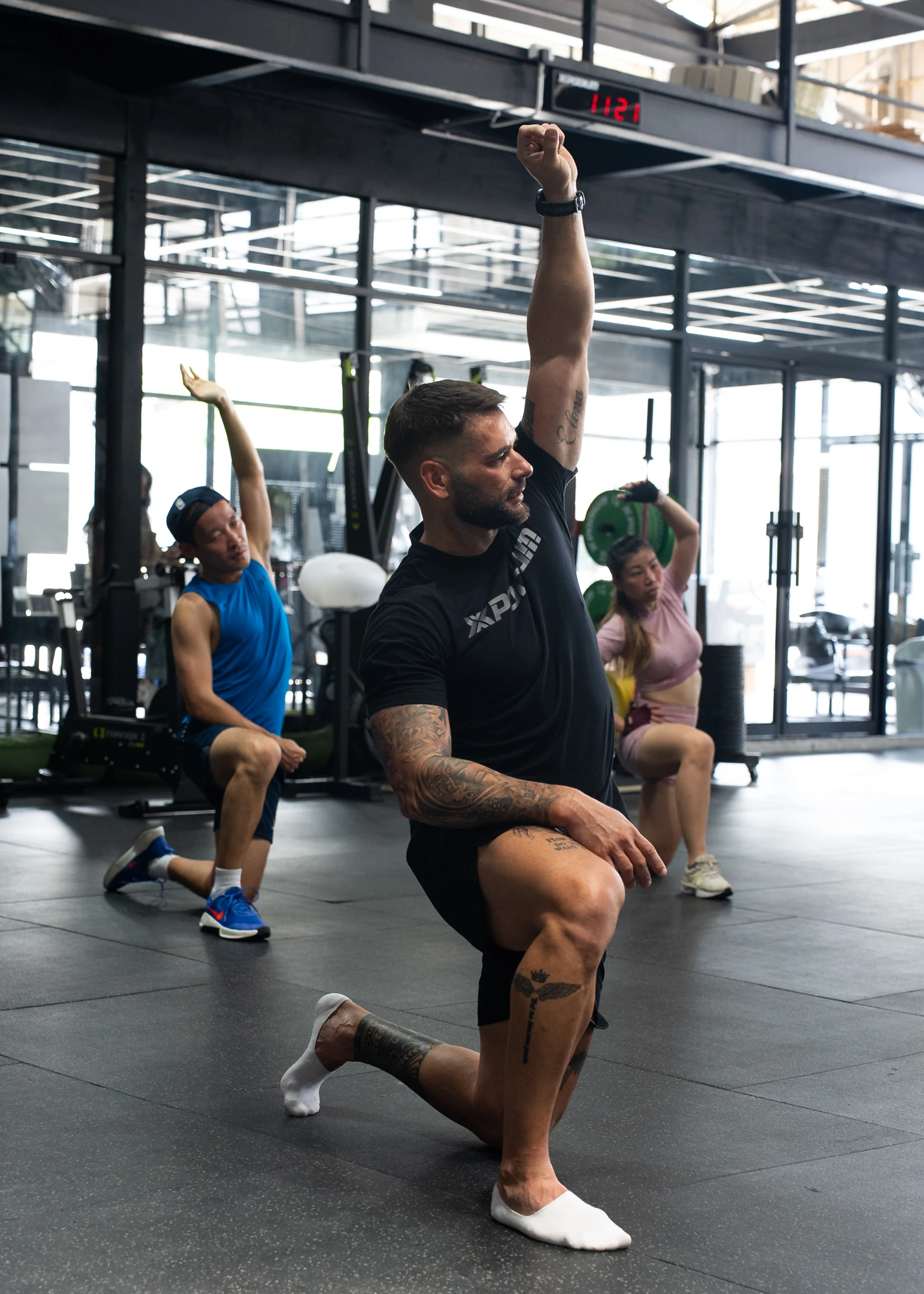 Steven demonstrating a movement with athletes beside him